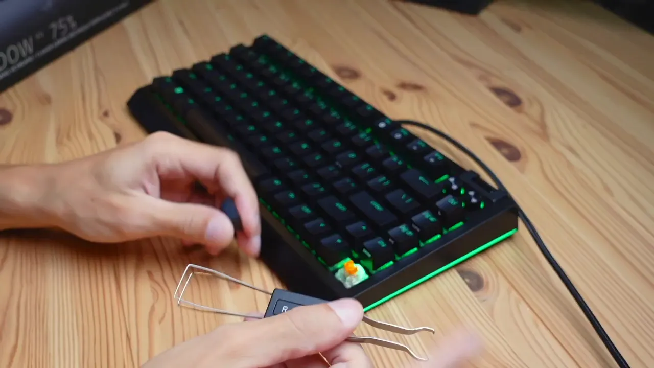 Keycap removal with included multi-tool revealing Razer Orange switch