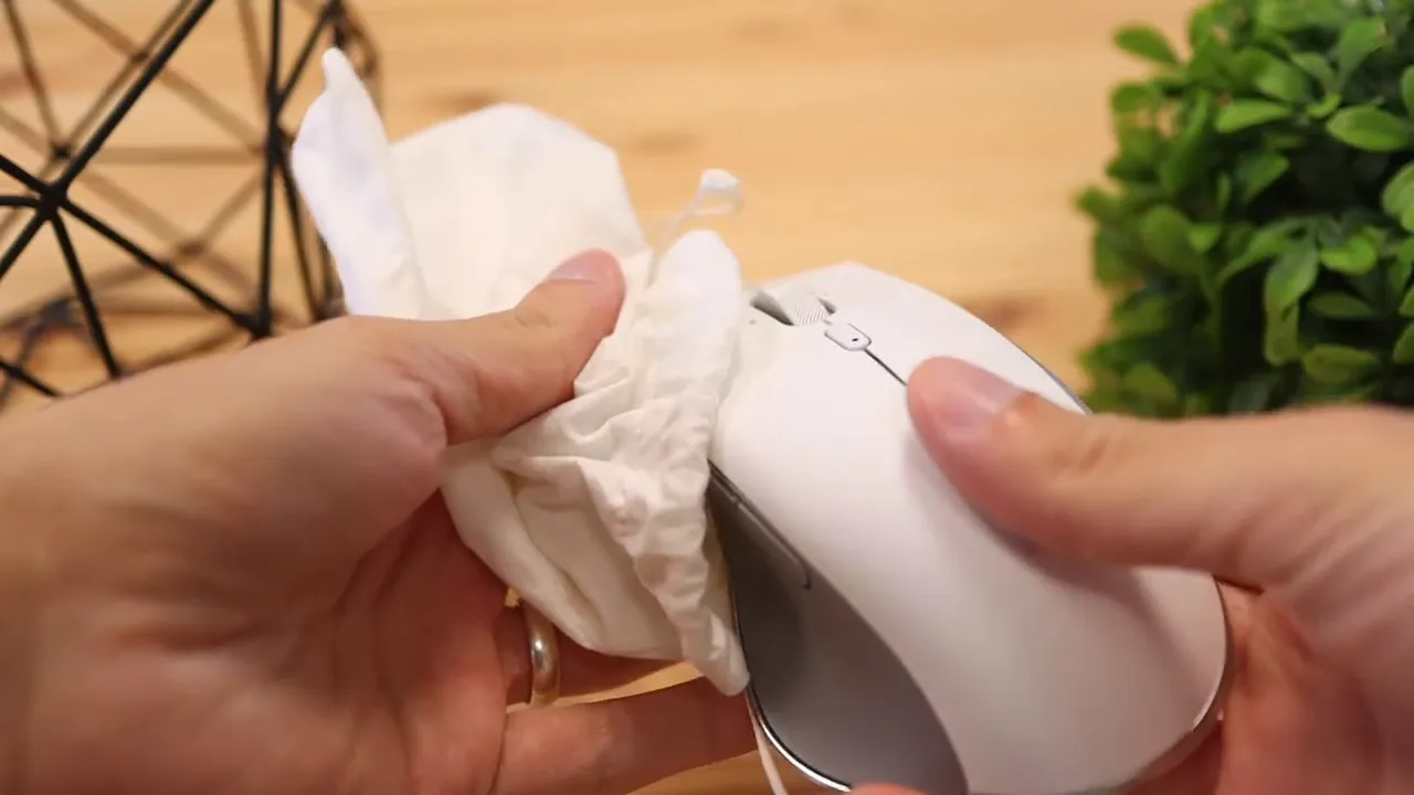 Bottom of the mouse with dongle and cover placed on the table