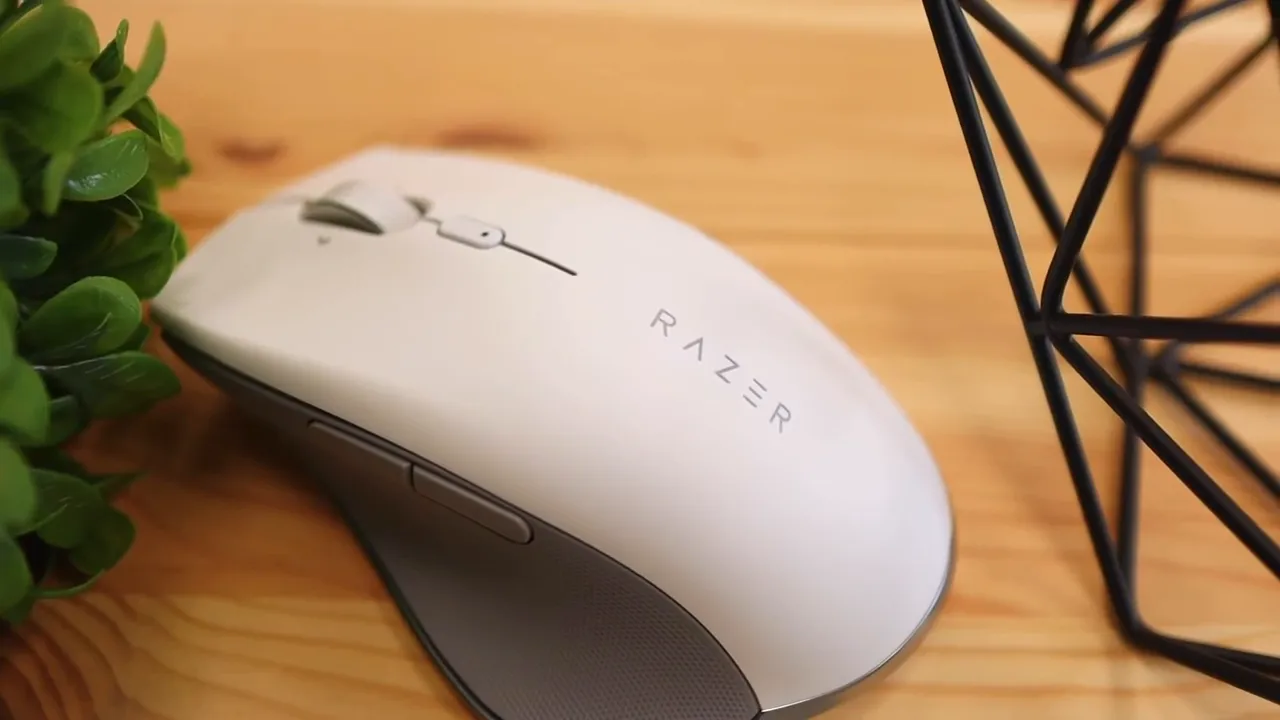 Angled top view of the white Razer Pro Click mouse on a wooden desk