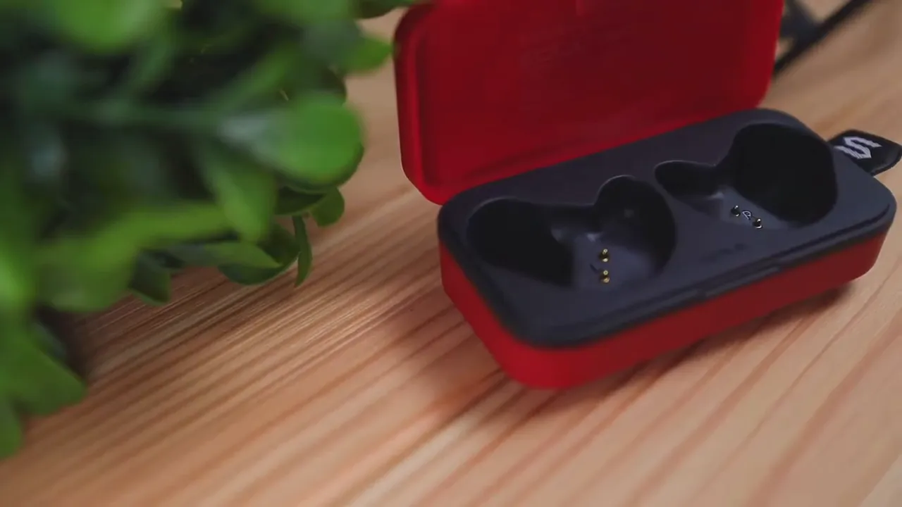 Soul S-FIT earbuds seated inside the red charging case close-up