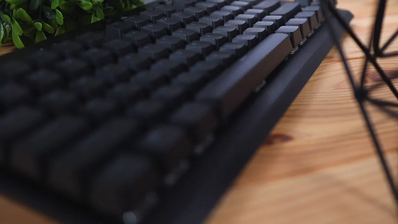 Low-angle close-up of Corsair K70 TKL showing compact profile and textured keycaps