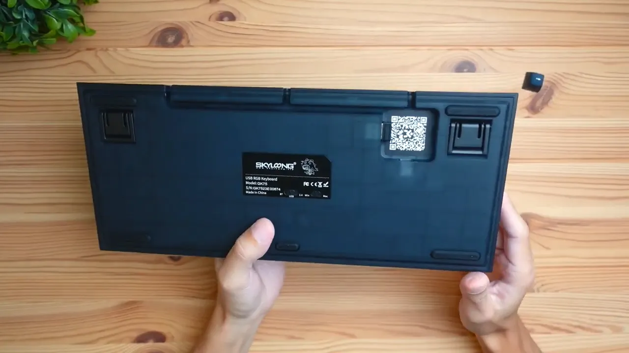 Back of the keyboard showing connectivity switches and USB receiver compartment