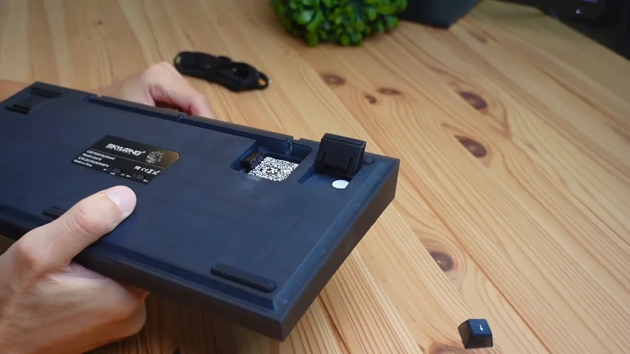 Underside view showing adjustable keyboard feet and cable channels