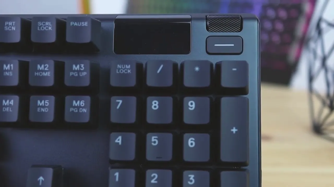 Top right corner of the SteelSeries Apex 5 showing small OLED display and media button