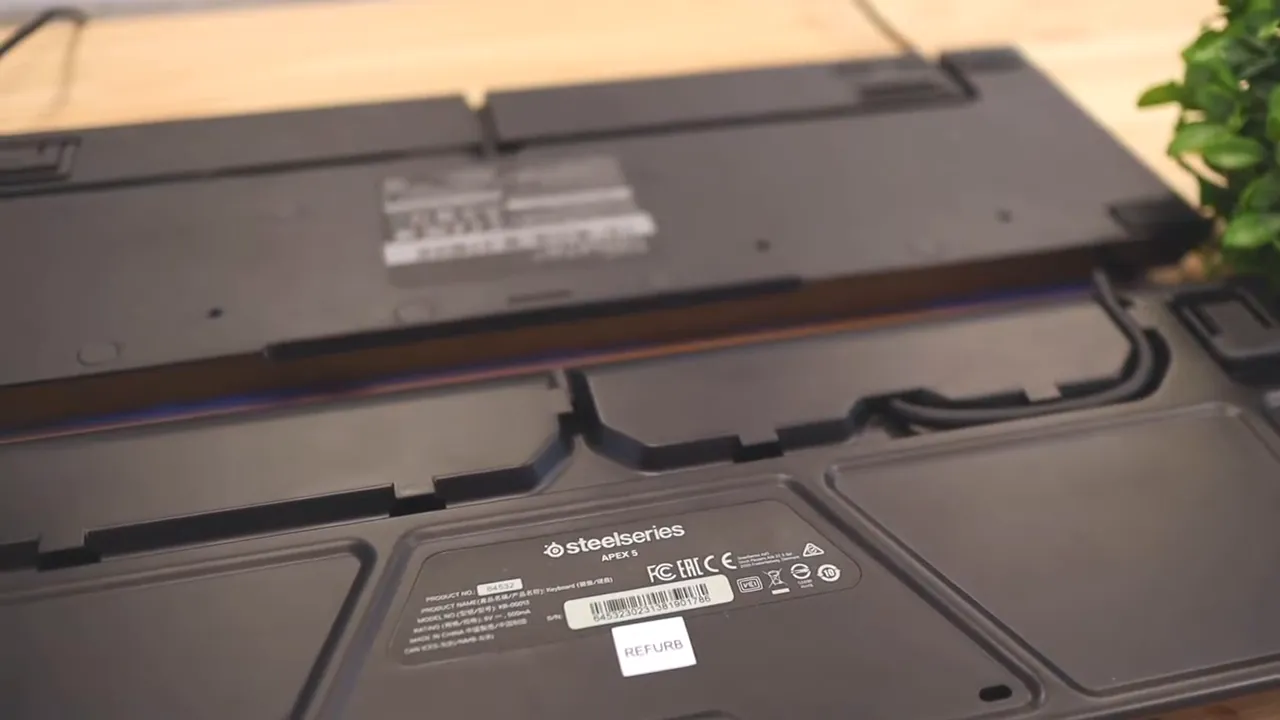 Underside of both keyboards showing molded cable routing channels