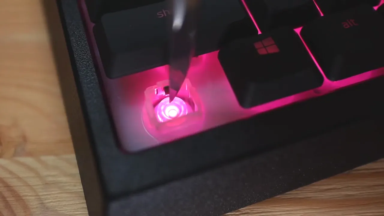 Closeup of illuminated switch housing under a Razer key with bright red lighting