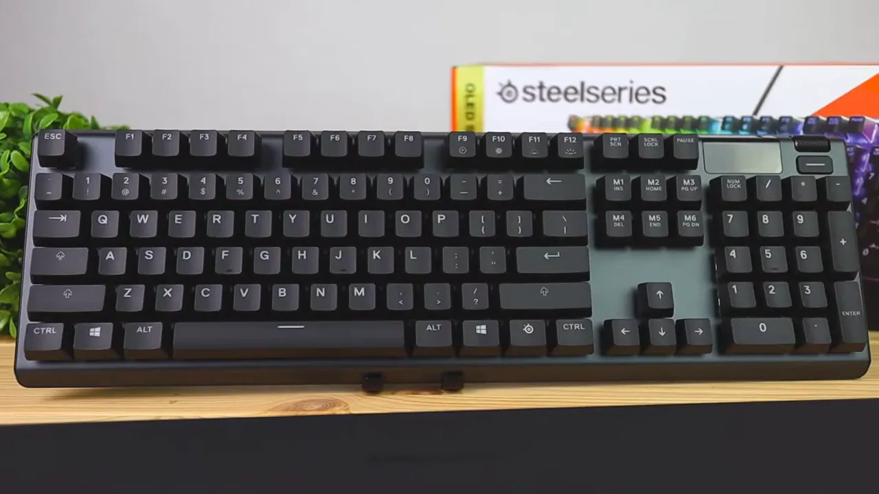 SteelSeries Apex 5 keyboard shown from above on a desk with product box behind it