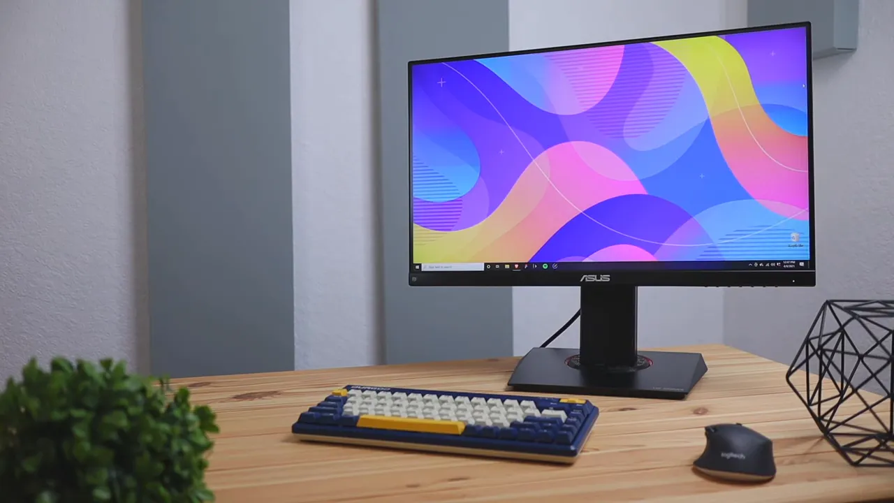 Front-facing ASUS TUF VG249Q monitor on desk with keyboard and mouse, clear view of the stand and thin bezels.
