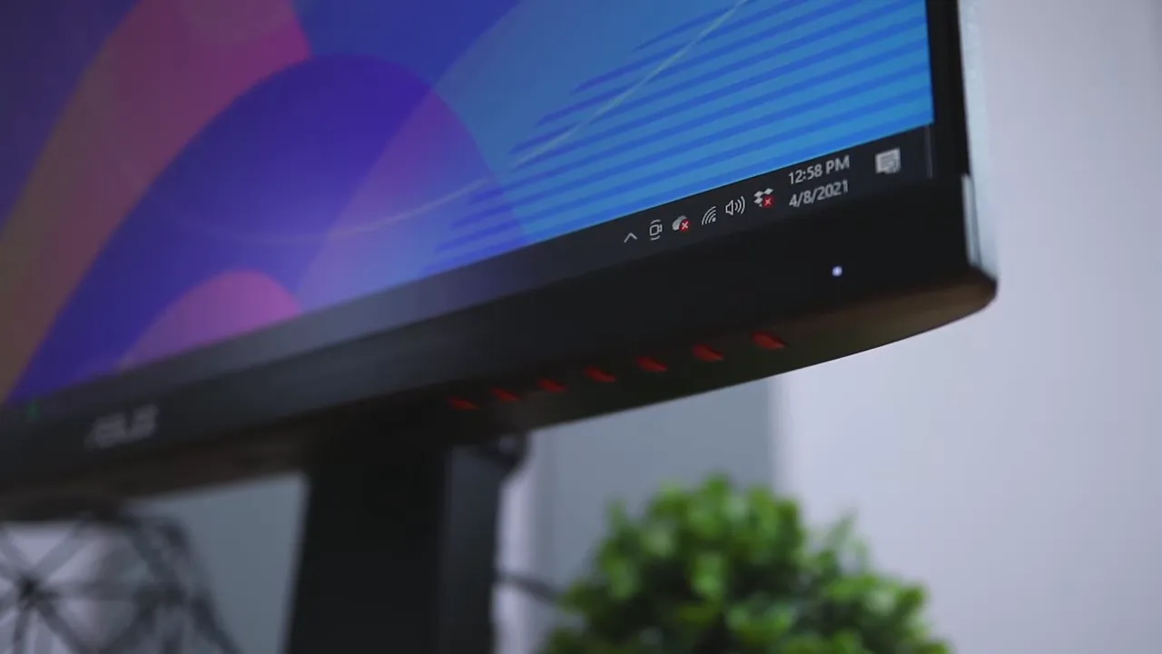 ASUS TUF VG249Q front corner with slim bezel red vent accents and status LED in sharp focus