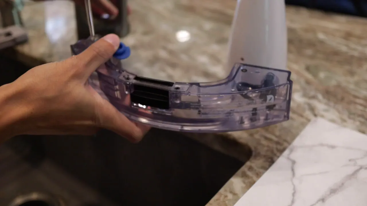 Detailed view of Yeedi water reservoir with blue fill valve