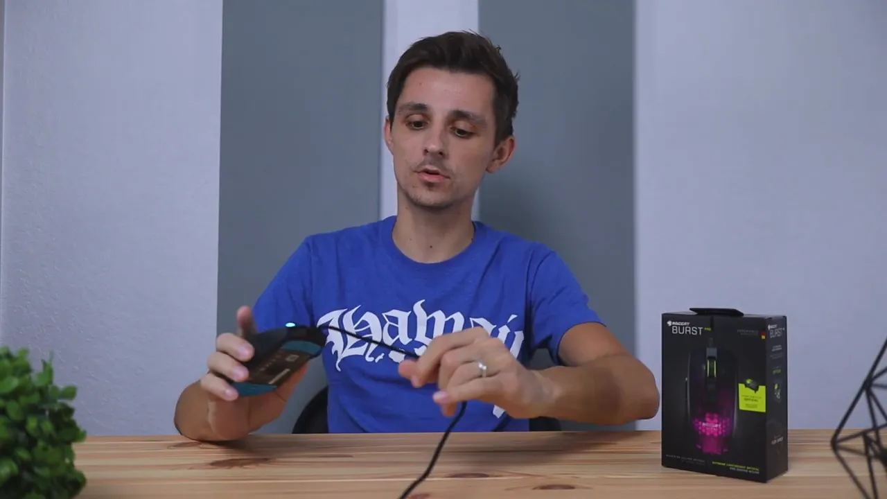 Roccat Burst Pro mouse with PhantomFlex cable held out while demonstrating cable flexibility