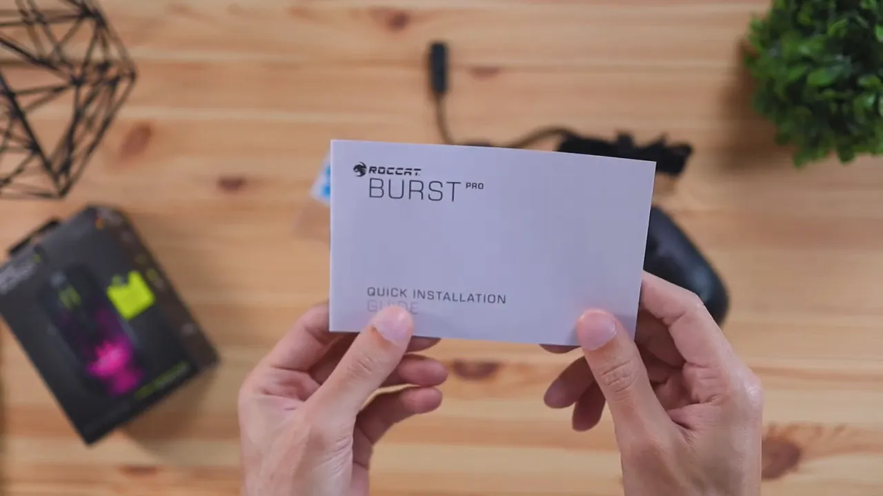 Roccat Burst Pro quick installation guide card shown in the hands