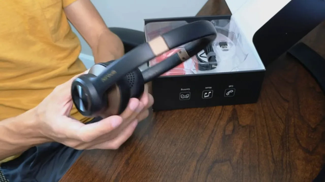 NUROUM HP30 headset showing brown trim and matte finish with packaging behind