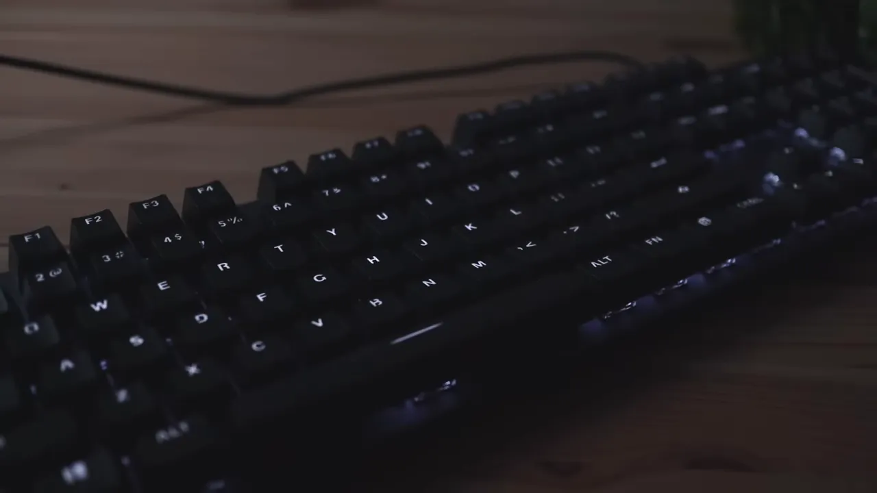 Close-up of Logitech K845 keyboard with white backlit key legends clearly visible