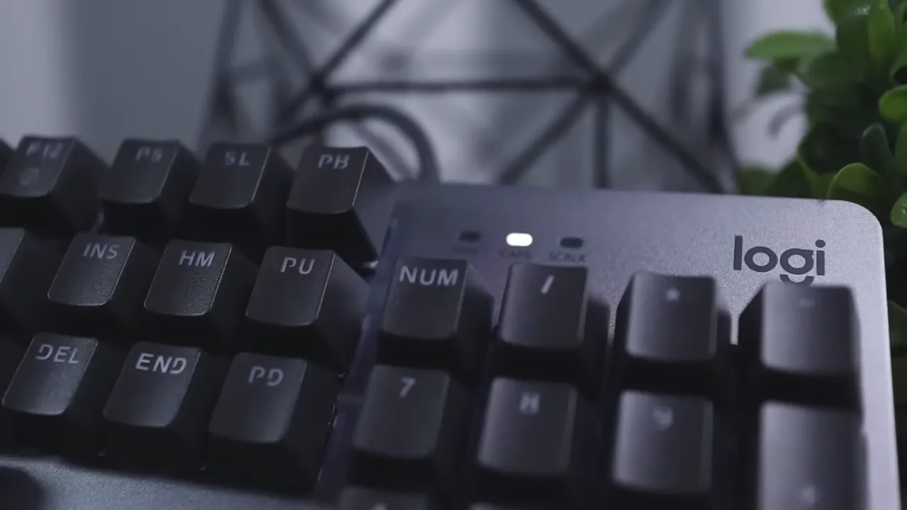 Logitech K845 matte aluminum top plate with caps lock indicator lit and logi logo