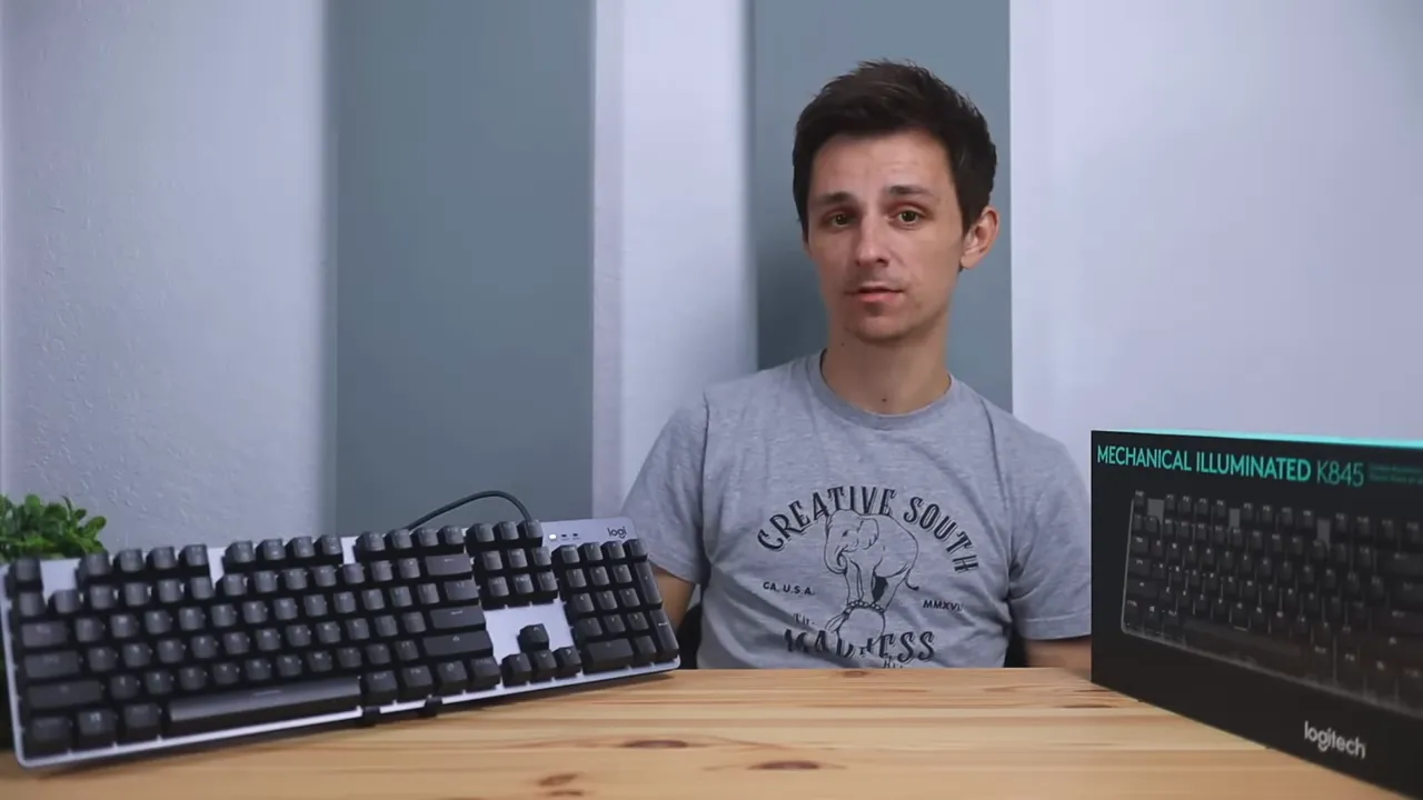 Full-size Logitech K845 mechanical keyboard on a desk with the number pad visible and the retail box to the right.