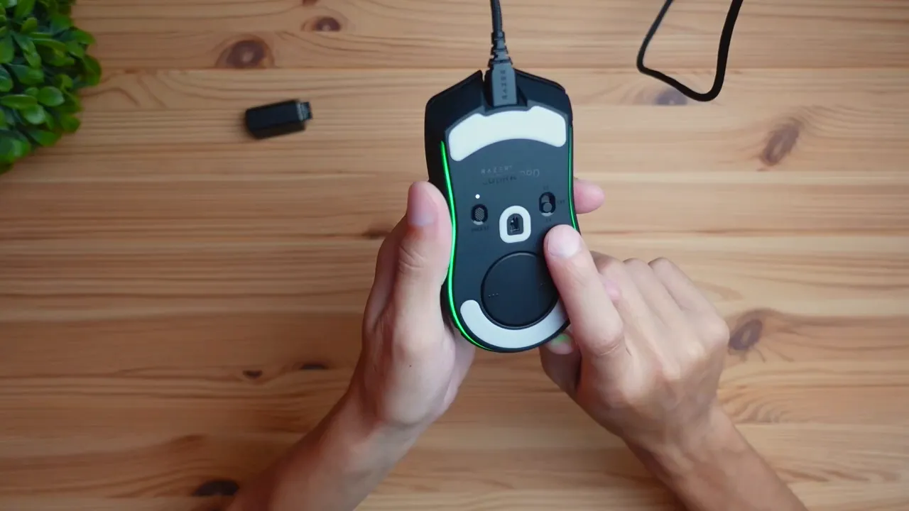 Bottom of the mouse showing power switch and dongle storage compartment