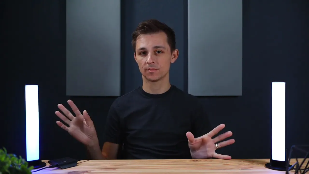 Centered presenter with two Govee LED light bars illuminated on either side on a wooden desk