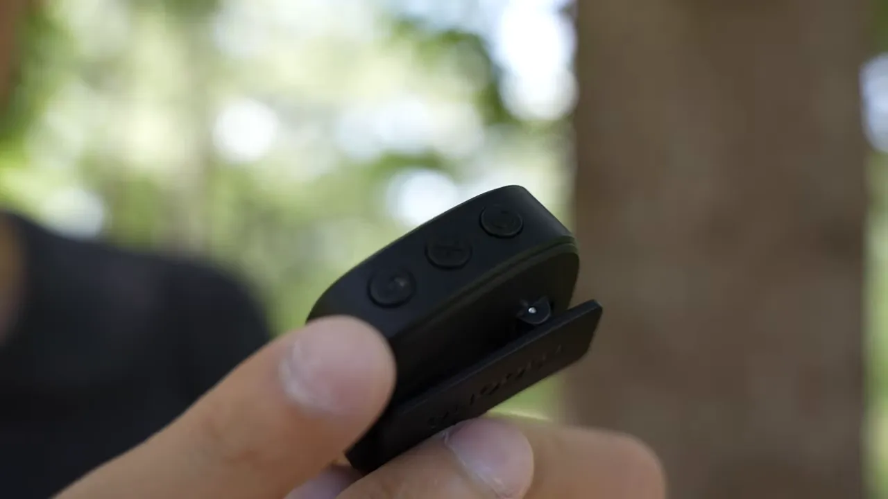 Sharp close-up of Maono WM820 transmitter showing three control buttons and clip