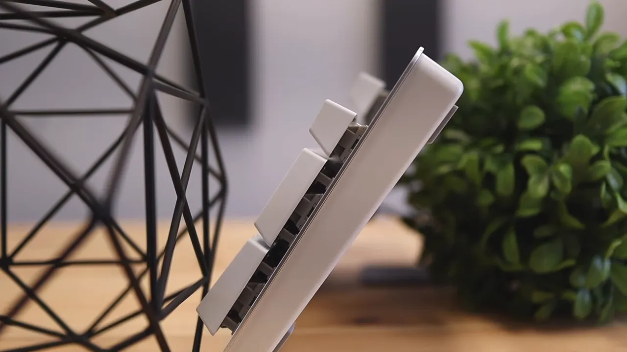Side profile of the white keyboard showing tall keycaps and elevated typing height