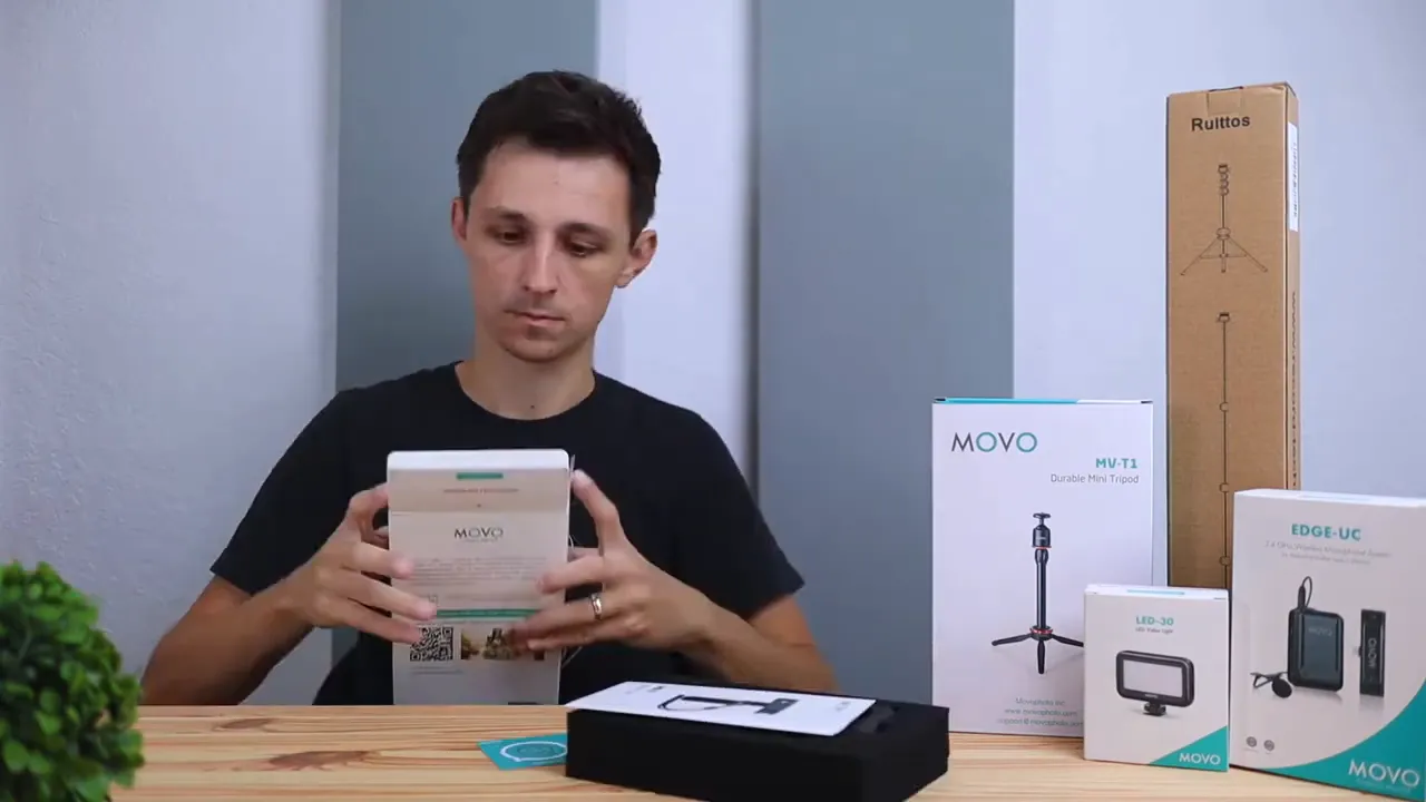 Desk with boxed Movo MU-T1 mini tripod, LED-30 light, other Movo boxes and a Ruittos tripod box