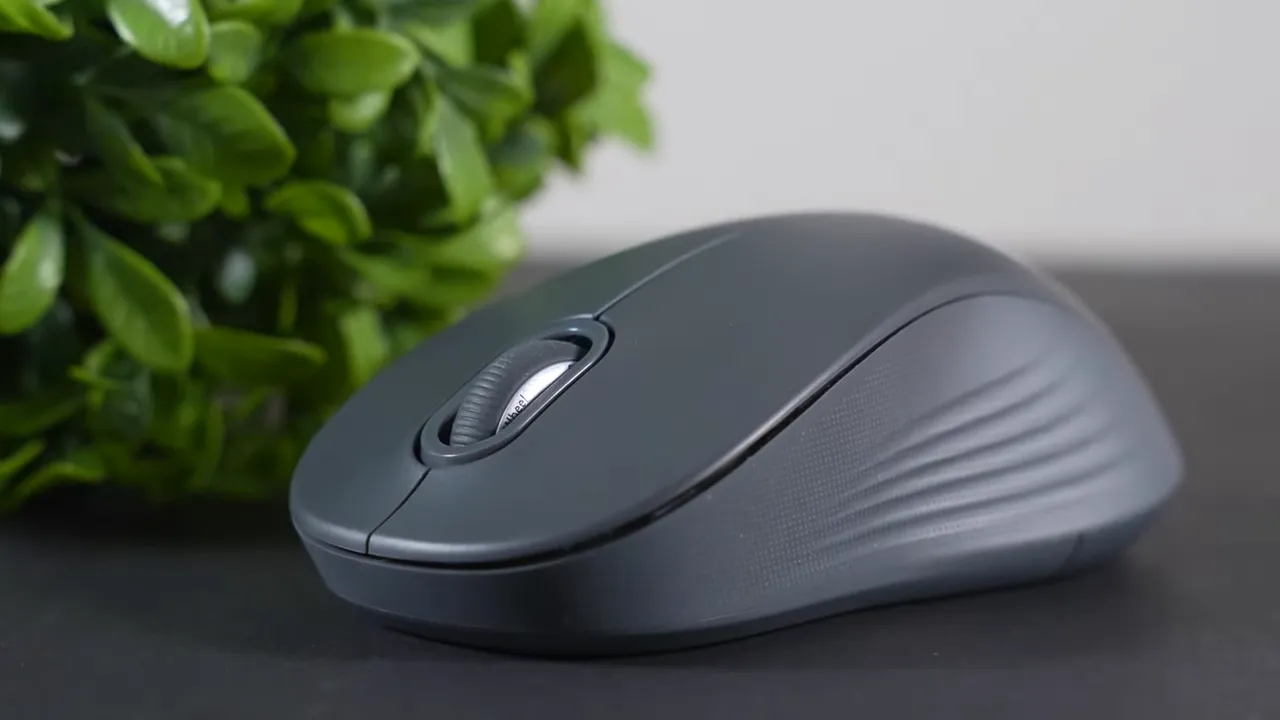 Detailed close-up of Logitech Signature M550 showing scroll wheel and textured side grip