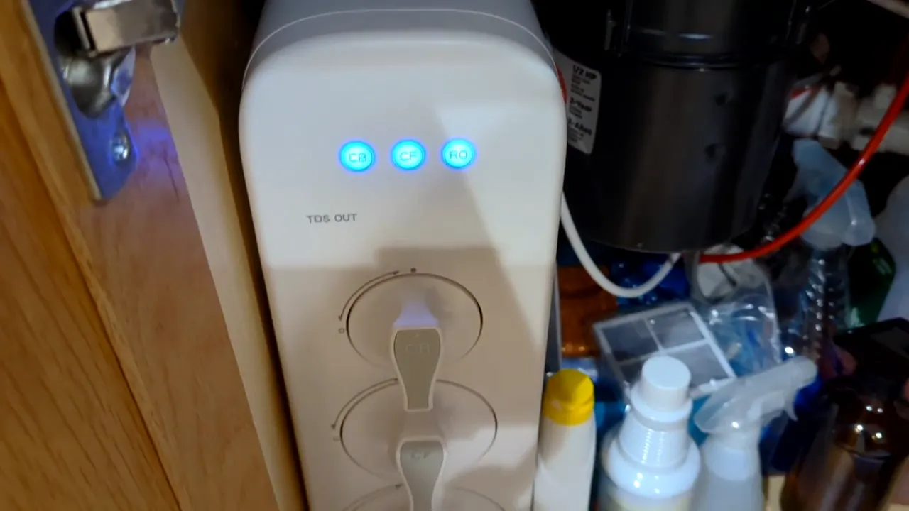 Waterdrop G3 under-sink unit showing three blue CB, CF, RO indicator lights, clear and well-lit.