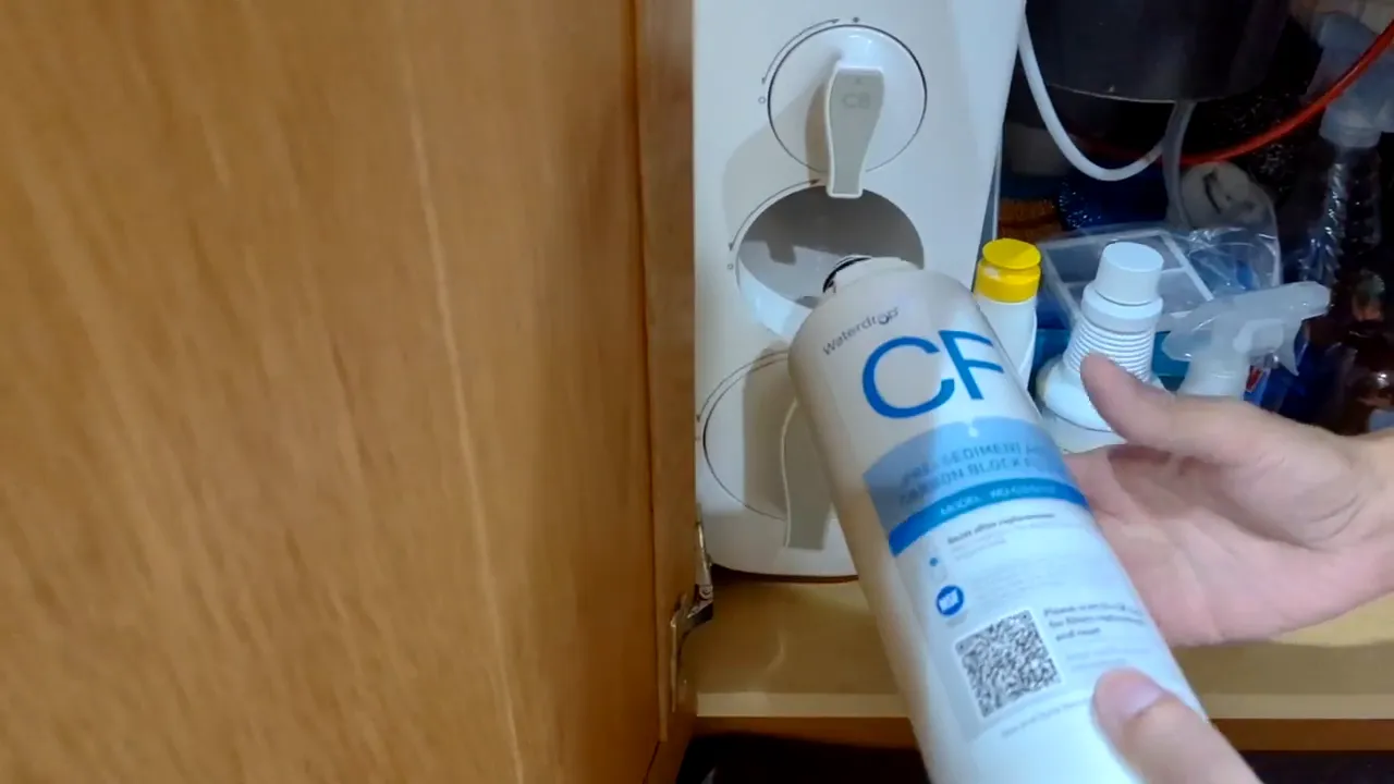 Aligning the CF replacement cartridge with the center slot of a Waterdrop G3 filter housing under the sink.