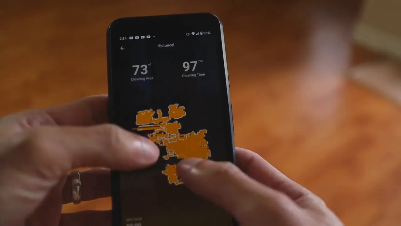 Smartphone displaying the MooSoo app map with cleaned areas highlighted in orange