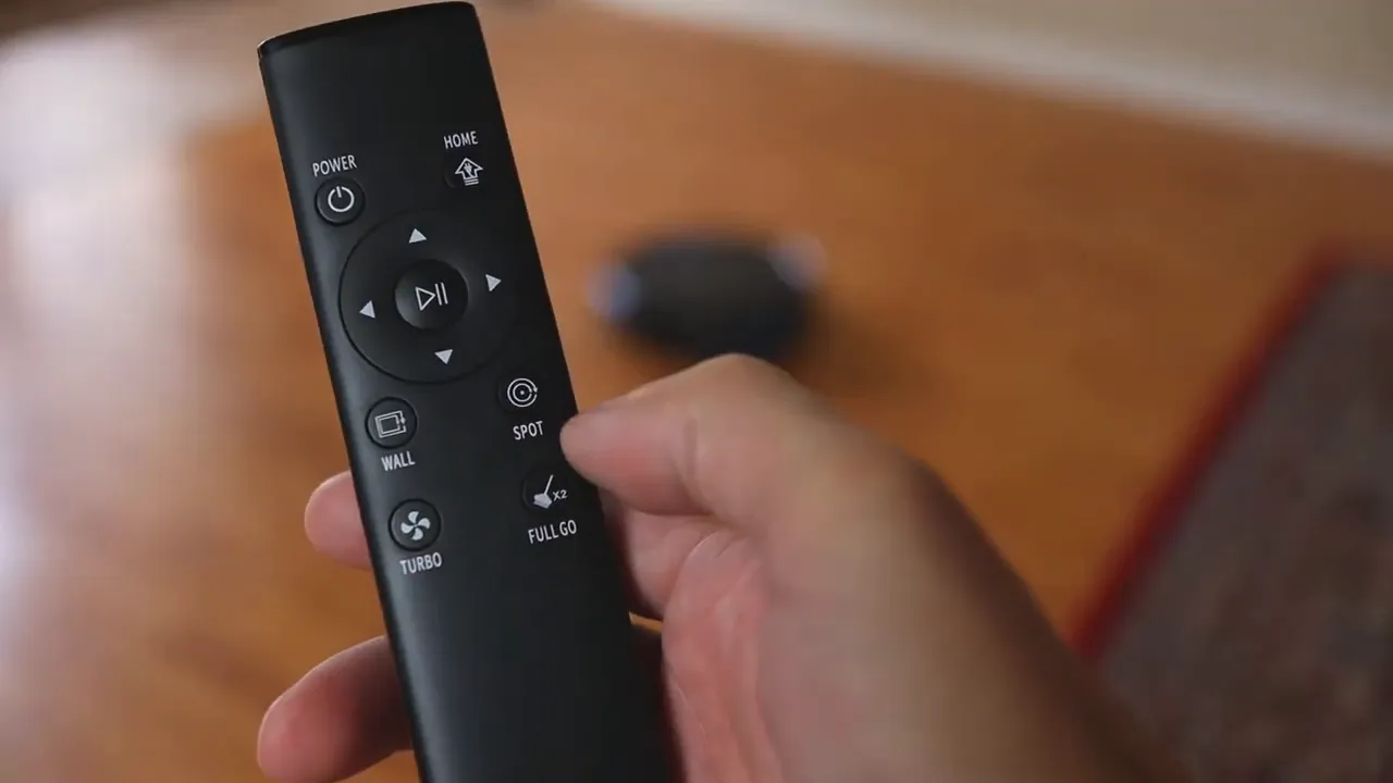 Close-up of the MooSoo MT-720 remote showing buttons labeled Power, Home, Wall, Spot, Turbo and Full Go