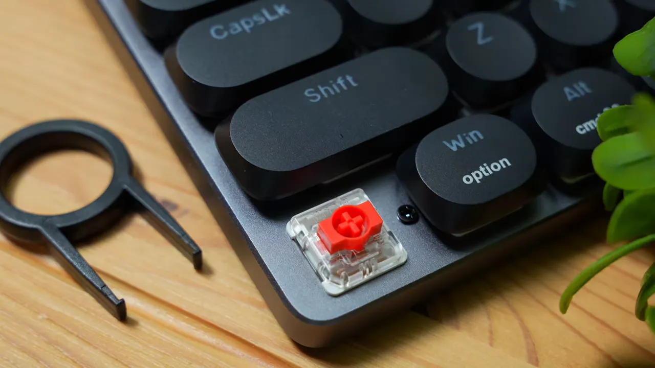 Removed keycap exposing red linear mechanical switch on ProtoArc MECH K300 next to included keycap puller