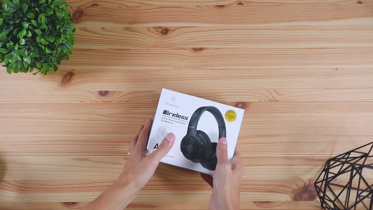 OneOdio A30 retail box on a wooden desk shown from above