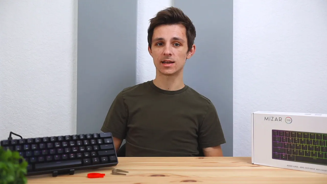 Mizar MZ60 Luna 60% mechanical keyboard with retail box on a desk