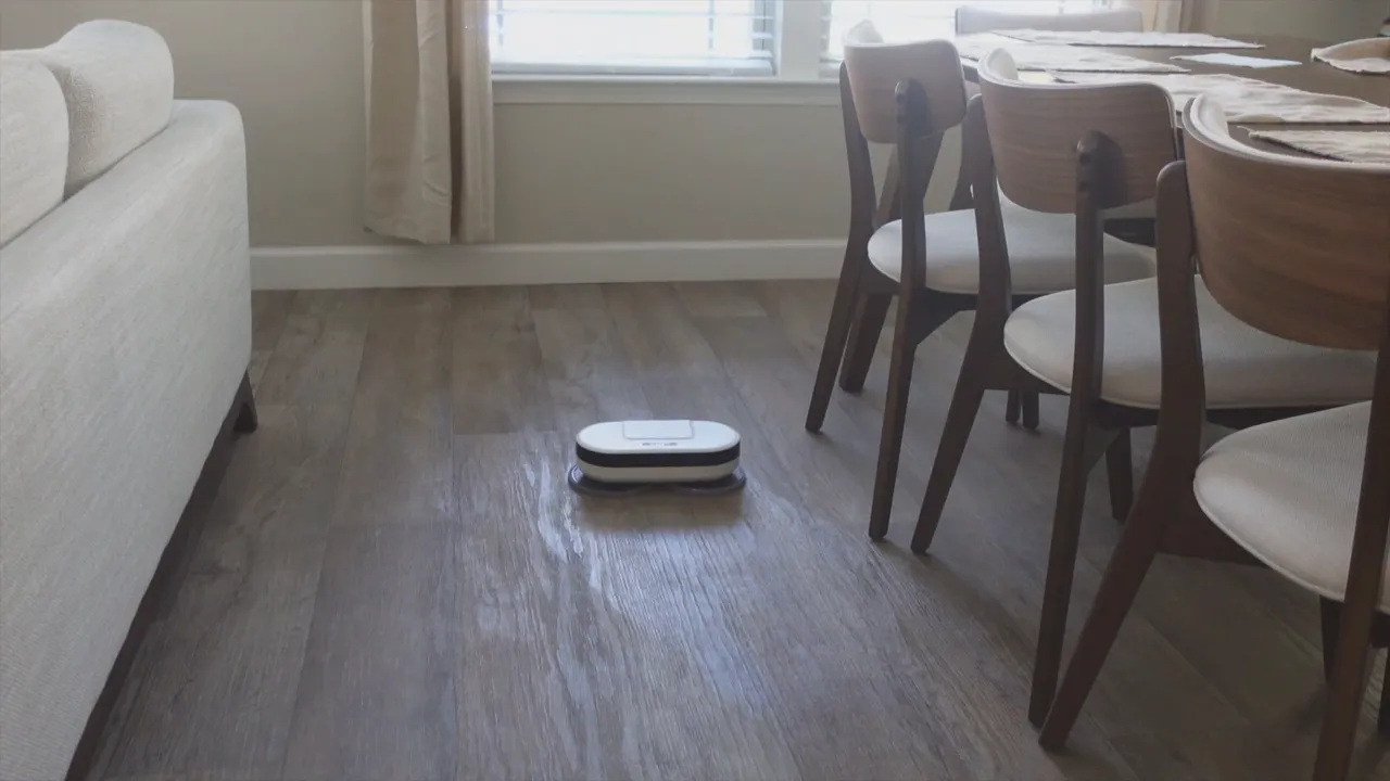 EVERYBOT Edge2 robot mop centered on the floor leaving a damp trail behind it