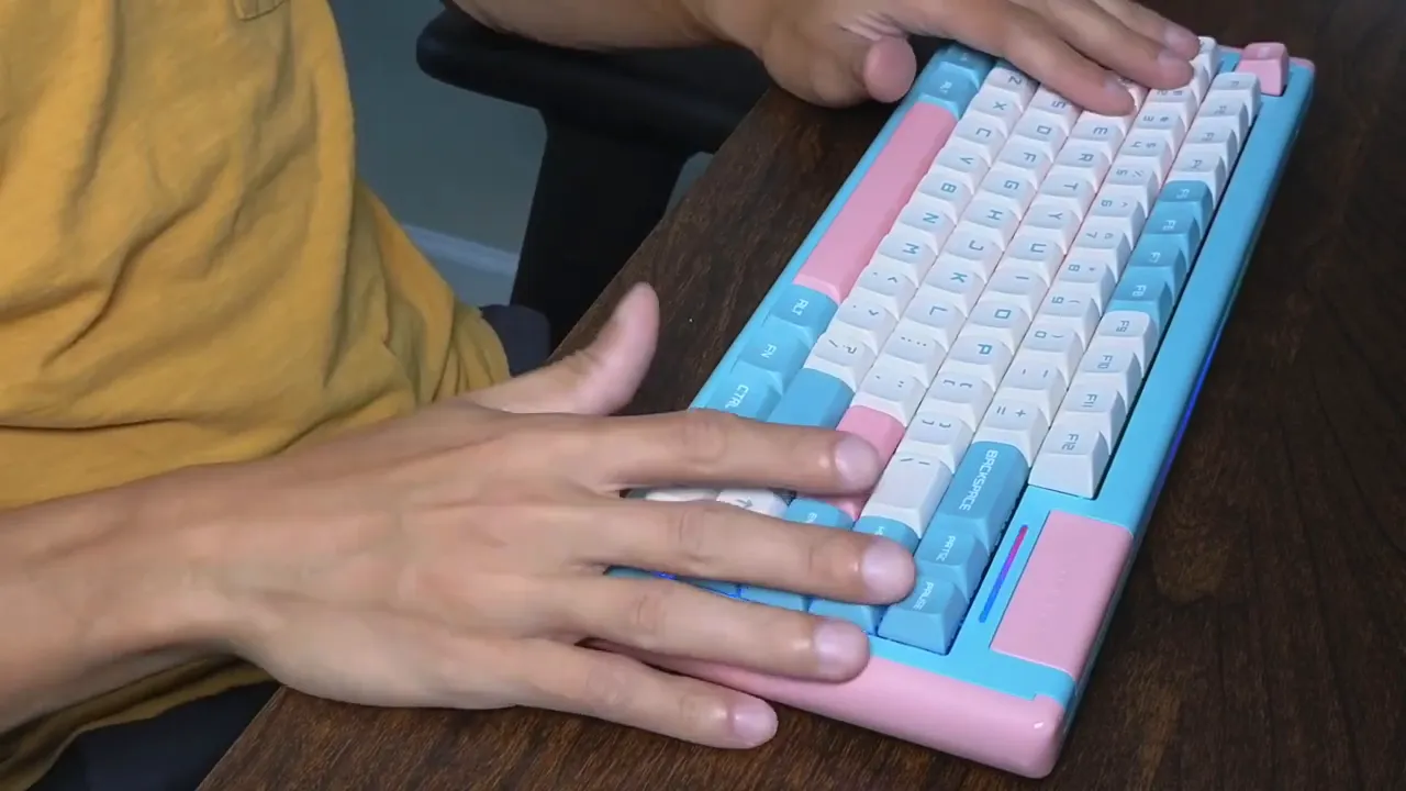 Top-side view of DUSTSILVER D84 keyboard showing a bright blue LED strip and underglow with hands typing