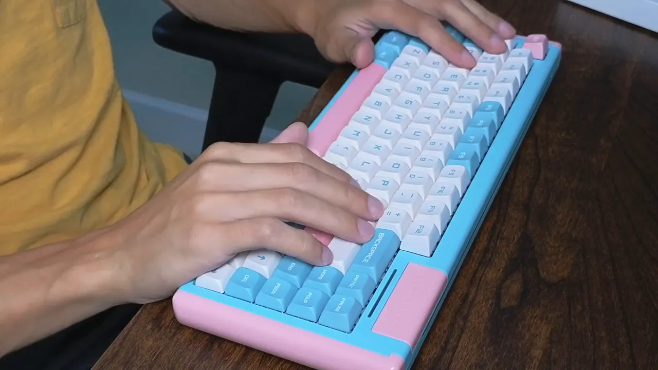Close-up of hands typing on DUSTSILVER D84 showing PBT keycaps and compact layout