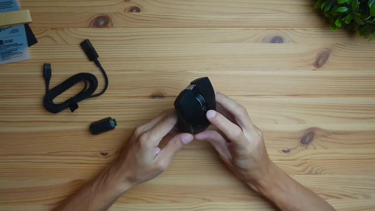Top-down of Razer Cobra Pro showing scroll wheel and top buttons on wooden desk