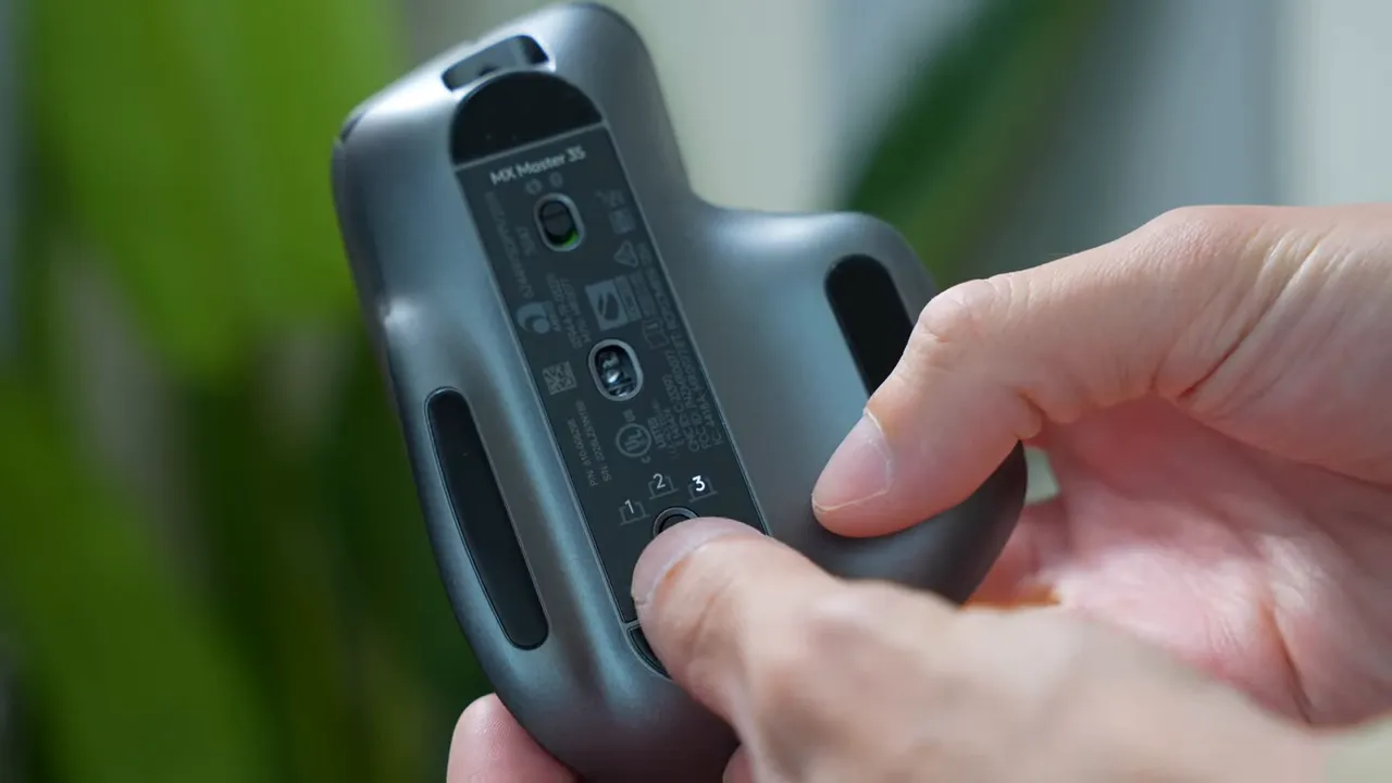 finger pressing mx master 3s bottom device-switch button labeled 1 2 3