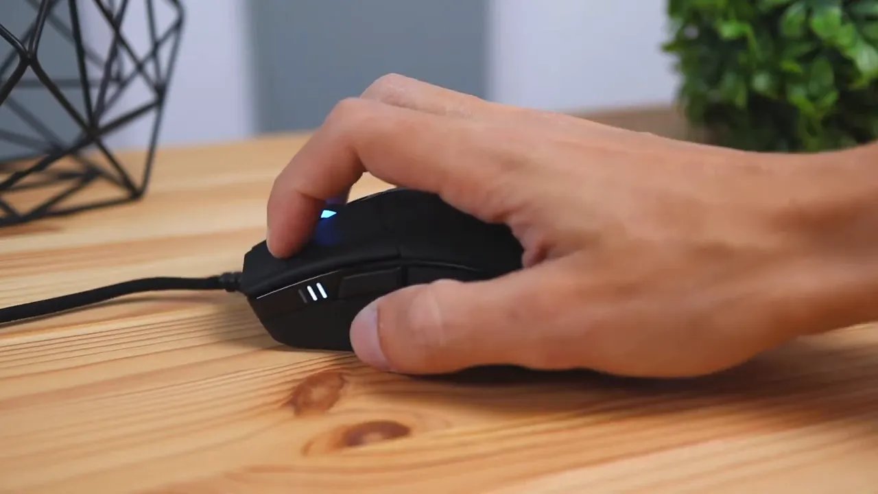 hand in a palm grip on the Corsair Sabre RGB Pro mouse showing side buttons and matte finish
