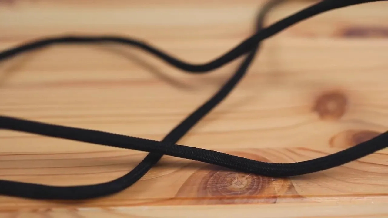 clear detailed shot of Corsair paracord-style mouse cable on wooden desk