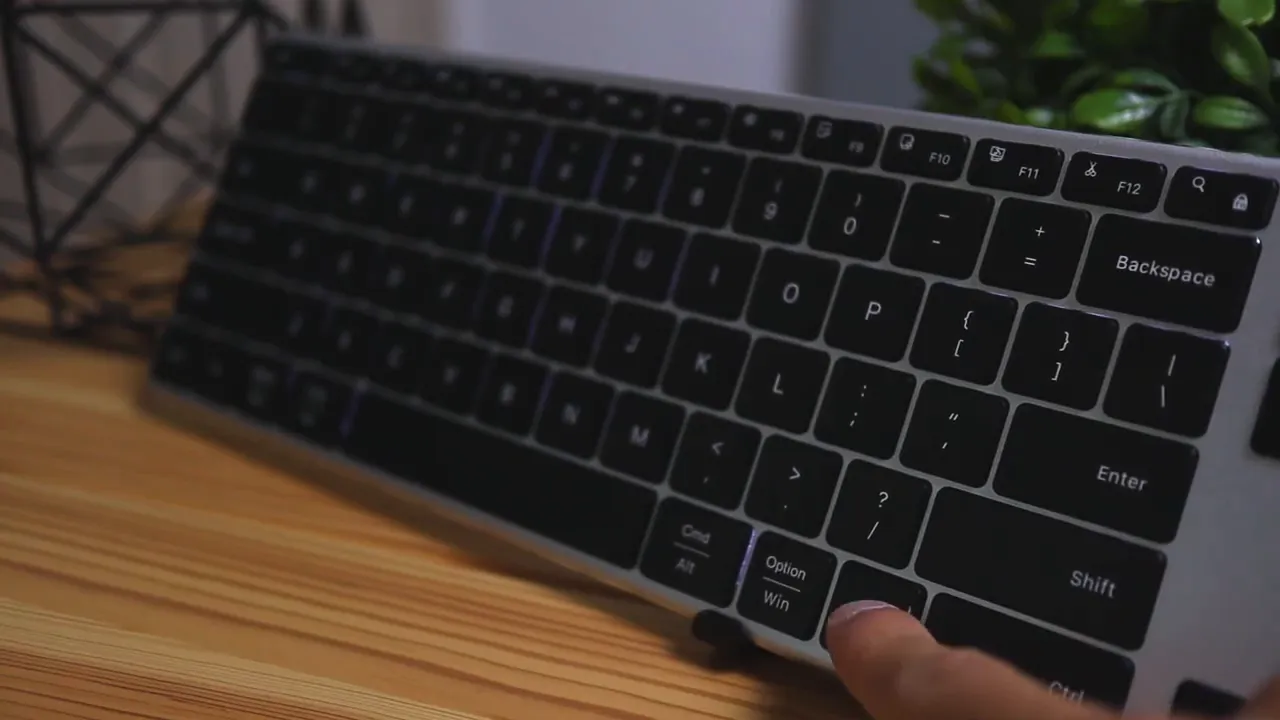 Close-up of Jelly Comb K62BA-3 keycaps showing backlight and a finger on the option key
