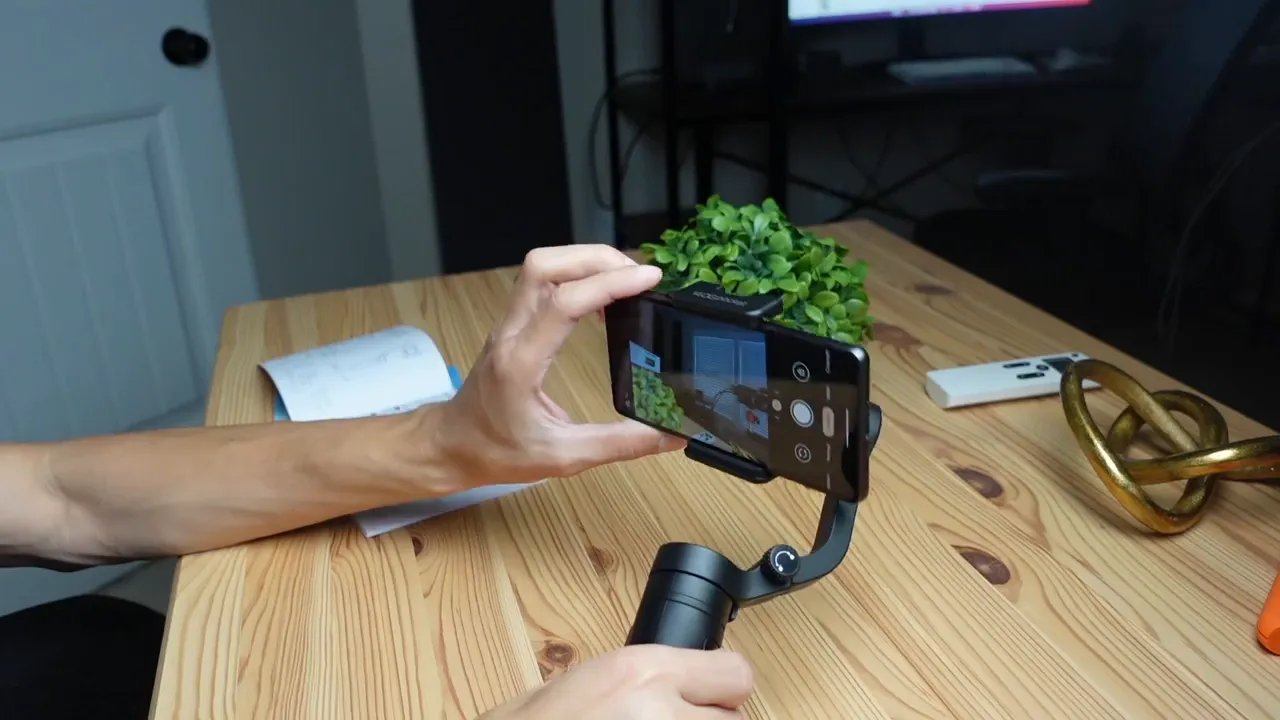 Smartphone secured in the FeiyuTech Vlog Pocket clamp showing the camera app