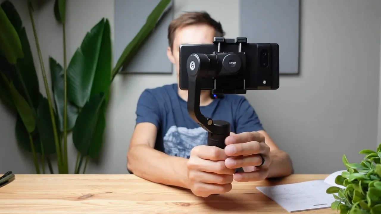 Front-facing shot of the FeiyuTech Vlog Pocket gimbal with phone mounted, centered on the handle and control area