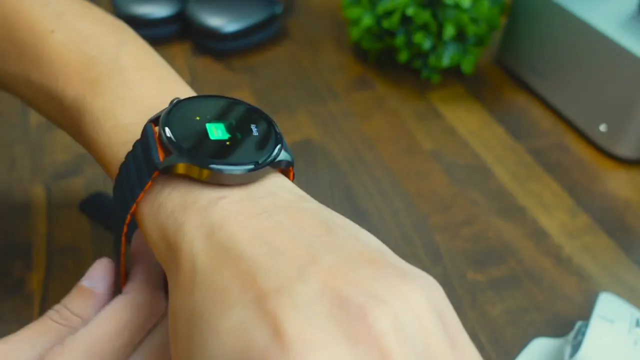 Imilab W13 smartwatch on wrist with magnetic strap being adjusted