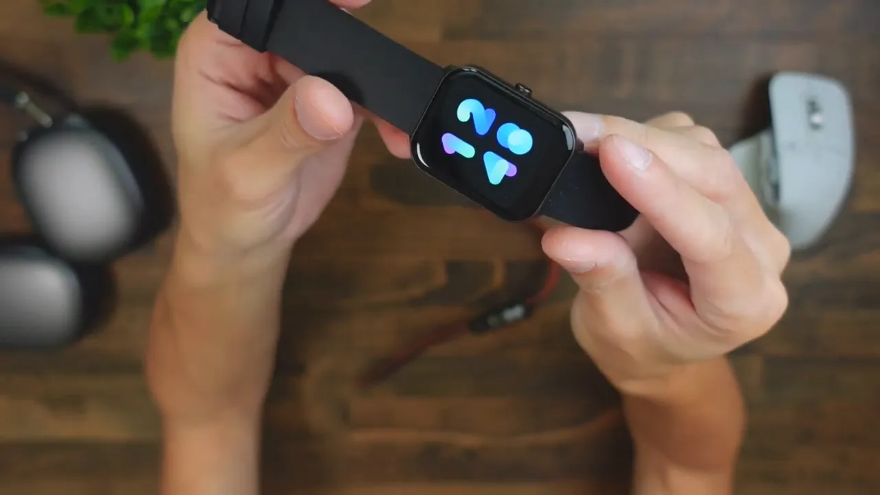 Imilab W01 square smartwatch held in hands showing a colorful watch face and black silicone strap