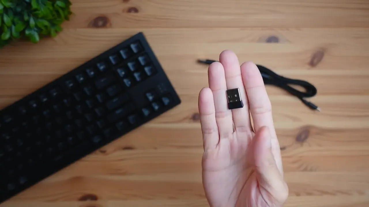Keyboard shown next to laptop representing Bluetooth, 2.4GHz, and wired USB-C connectivity options