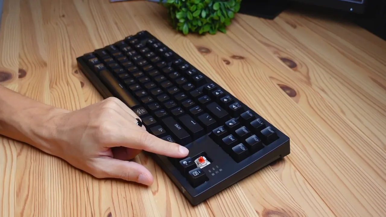 Keycap puller removed exposing red linear switches beneath keycaps