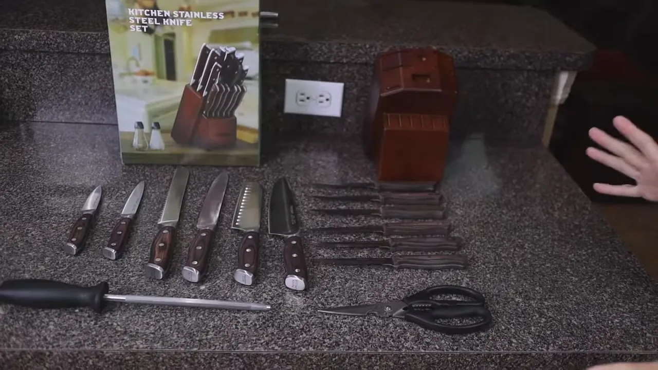 All knives, steak knives, scissors, sharpening rod, block, and packaging arranged on the countertop