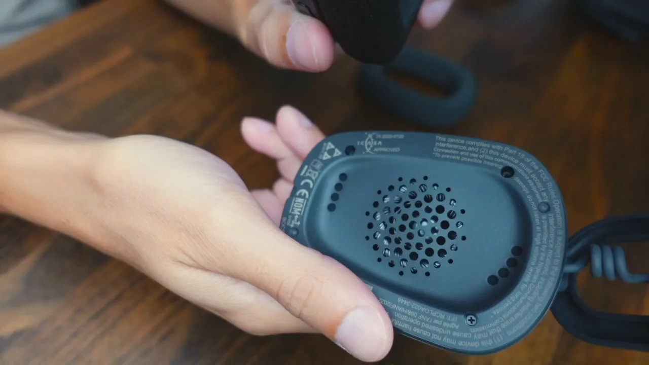 Close-up of speaker inside ear cup and fabric ear pad