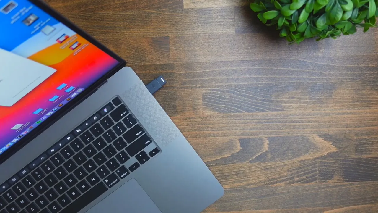 USB receiver being plugged in via USB-C adapter on a laptop